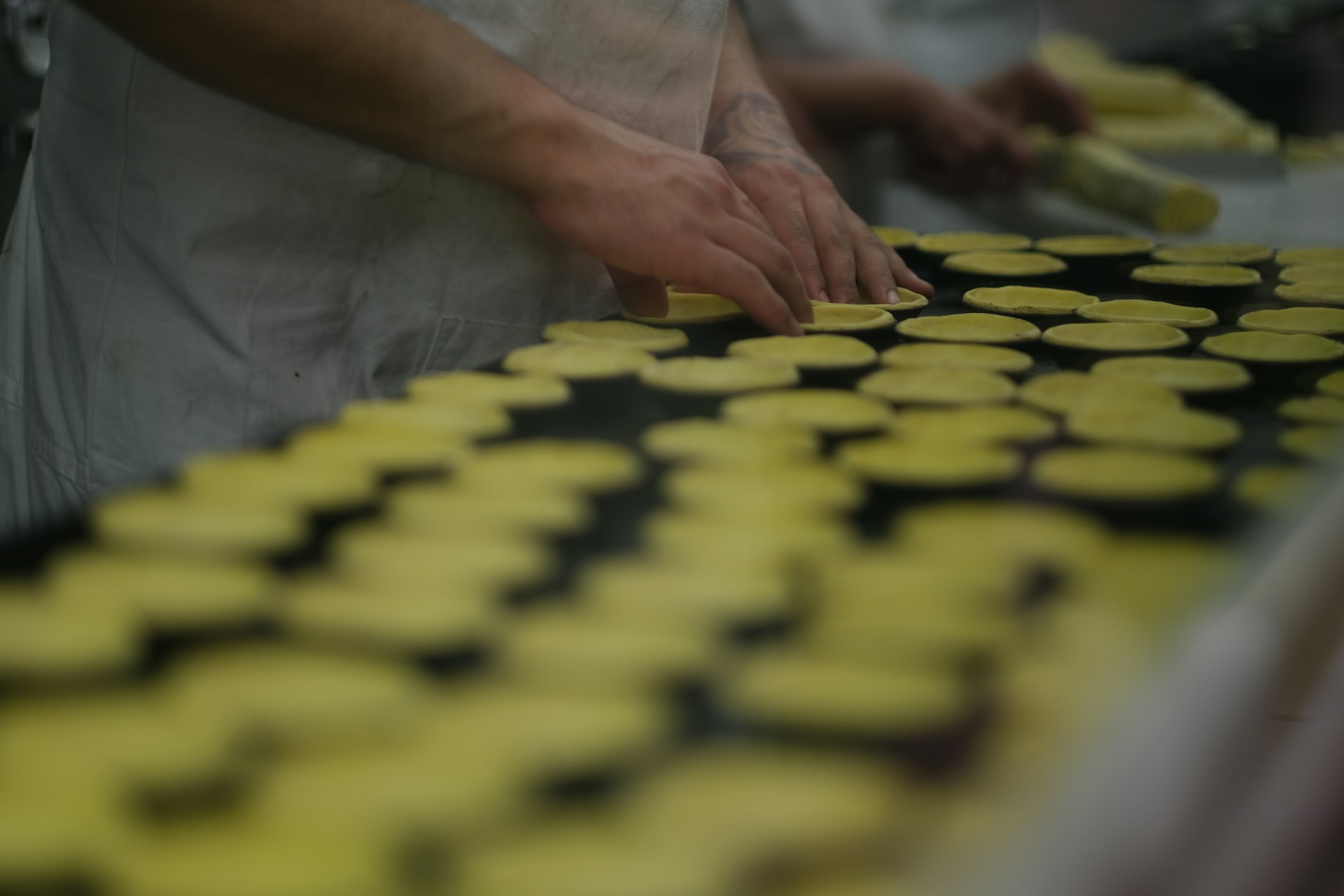 A bakery worker accurately preparing wholesale orders.