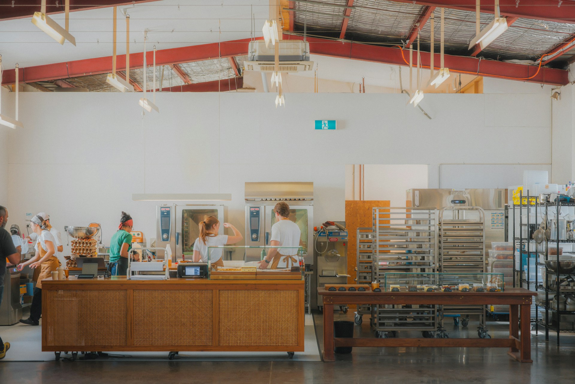 A small team of workers in a busy bakery.