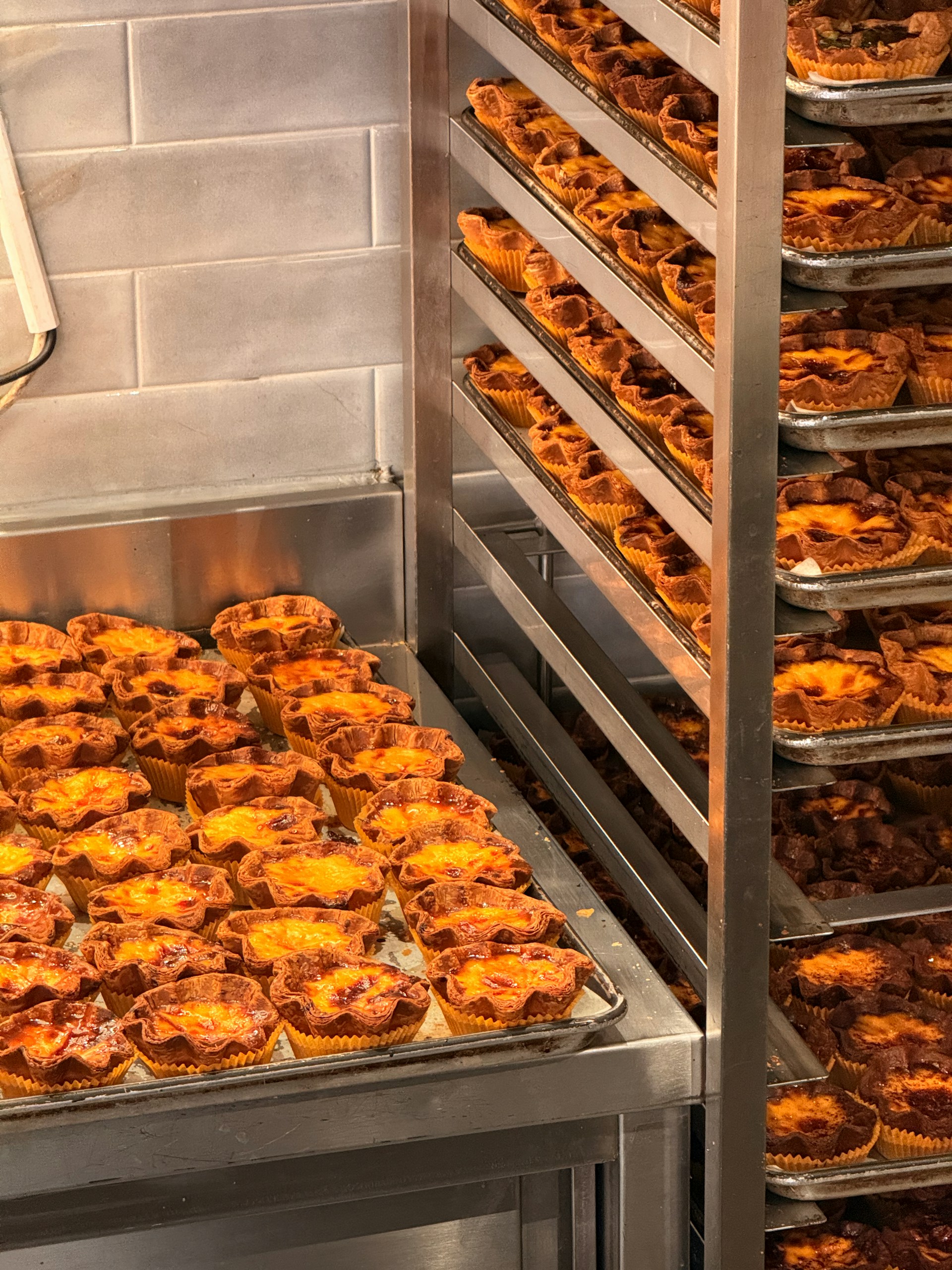 Racks of wholesale bakery goods ready for packing.